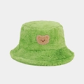 Detail of soft green faux fur bucket hat featuring a cute brown bear embroidery patch - One Size / Green