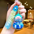 Close-up of a blue liquid keychain featuring a cute pig charm and Bubble soft strap - Gradient Rope [dark Blue] Glow-in-the-dark Pvc Peach Pig