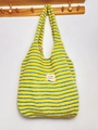 Close-up of yellow and blue striped plush tote bag hanging on a wooden hook. - Vest Bag / Yellow Stripe