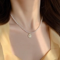 Collana di perle barocche con pendente a rosa in rilievo dorato indossata da una modella - 27-Collana di rose in perle artificiali