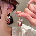 Close-up of gold butterfly earrings with green zircon and red teardrop gems on a model - 16# Hook-Gold-Pink
