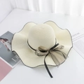 Detail of wide-brim straw hat with black wavy edge and polka dot ribbon bow - M (56-58cm) / White