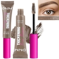 Detailed view of eyebrow mascara wand with fibers and swatches for thickening brows - Khaki