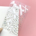 Detail of white ribbon bow and iridescent rhinestones for fairy eye makeup looks - BJA-638 (White Bow Tie)