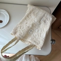 Close-up of exquisite floral lace embroidery and rectangular fabric label on the cotton tote - Bone Rope Mesh Embroidery