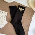 Black ribbed mid-calf socks featuring exquisite beaded bee patch embroidery on a soft fabric - One Size / Black