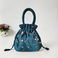 Ethnic embroidery bucket bag in navy blue silk texture with tassels and drawstring closure - Teal