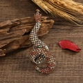Detailed close-up of a vintage snake brooch with amber rhinestones on a rustic wood background - Full Rhinestone Large Snake