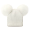 Detail showing soft white knit fabric texture and fluffy plush pom-pom ears on winter hat - White