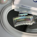 Iridescent transparent hair claw clip with laser finish on a white reflective surface - Large Square Mermaid