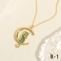 Macro shot of the 18K gold plated moon and cat pendant with green gradient stones - Golden Gradient Green Cat Moon (NE2147-B-1)