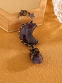 Macro shot of vintage bronze moon pendant with deep purple raw crystal stone - Purple Crystal