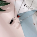 Macro detail of couple necklaces with magnetic heart and hexagonal crystal stone pendants - Black Stone + Rose Quartz