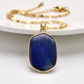 Gold stainless steel necklace featuring an oval lapis lazuli pendant with natural textures - Oval (Square)