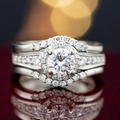 Three-piece bridal ring set with round halo cubic zirconia and side stones in white gold plating - US 6