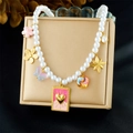 Detail view of pearl necklace with pink tarot love heart and star charms on gold stand - LOVE Card Star Butterfly Style (N3735)