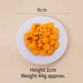 Realistic 9cm artificial corn snack food model with black sesame detail on white plate - 9cm / Corn Cake - No Keychain