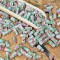 Macro shot of 8mm cylindrical marble pattern ceramic beads for DIY jewelry making - Yan Green (Green Red Marble)