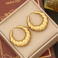 Macro shot of chunky golden hoop earrings with textured finish on beige jewelry display - Twisted Hoop Style (7#)