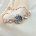 Elegant rose gold women watch with rhinestone bezel on soft silk fabric background - Black