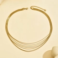 Detail of layered gold snake chain necklace with lobster clasp and adjustable extension - 14k / Gold