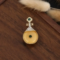 Detailed macro view of a vintage Chinese style pipa brooch with gold and green gems - Emerald Disk Pipa