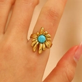Vintage gold sunflower ring with round turquoise stone on woman hand in warm tones - Sunflower Floral Style (DZ-1062) / Gold / Turquoise