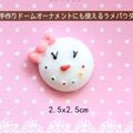 Macro view of a 2.5x2.5cm resin snowman face with pink bow for DIY phone case crafts - Snow Baby