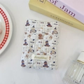 Detail of light blue quilted passport holder featuring a cute puppy print and fabric label - Skating Dog