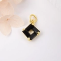 Square gold pendant with black baguette-cut zircons and metal clasp on white background - Black