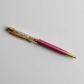 Detail of pink metal ballpoint pen with yellow crystal stones in transparent barrel - Citrine / 14cm Black Ink Refill