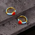 Detailed close-up of blue enamel and red heart hoop earrings on a textured stone - Blue Heart Style (EH0188 Blue)