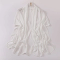 Detail showing the elegant drape of white translucent chiffon shawl on wooden hanger - White