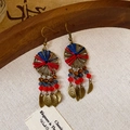 Detail of bohemian earrings with red and blue thread, crystal beads, and metal leaf charms - Round Glass Bead Leaf Tassel Style