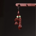 Detail of hand-carved wood dragon pendant and brush with cultural calligraphy art - Dragon Brush Handwriting