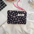 Detail of floral quilted cotton pouch featuring black fabric and pink flower patterns - Black with Pink Floral