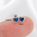 Navy blue heart stud earrings in polished silver finish shown on a fingertip - Silver-Blue Heart