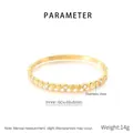 Detail view of gold stainless steel bangle with cylinder motifs and cubic zirconia accents - Cylindrical Zirconia Inlaid Style (KB210756-KSZ)