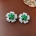 Macro detail of emerald green flower earrings with cubic zirconia on brown leather - Green (925 Sterling Silver Earring Post)