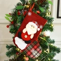 Red plaid Christmas stocking with 3D Santa Claus plush hanging on festive tree - Christmas Santa Sock