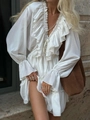 Elegant white V-neck dress with layered ruffles and long sleeves shown in an outdoor street setting - S / White