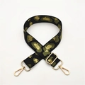 Detail of leopard print bag strap with gold metal hardware and adjustable buckles - Green