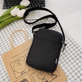 Minimalist black canvas crossbody phone bag with adjustable strap and sport logo - Black