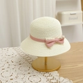 Detail of children straw sun hat featuring a sweet pink polka dot bow on creamy woven texture - Off-white Hat