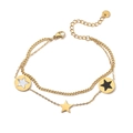 Detailed shot of double-layer stainless steel star charms with white and black inlay - Gold Star Round Disc / Gold