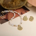 Detailed view of ocean style golden snail shell pendant and matching pearl necklace - Gold Smooth Conch Pearl Set