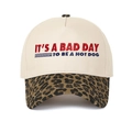 Detail of five-panel baseball cap with leopard print brim and red-blue text embroidery - Leopard Print