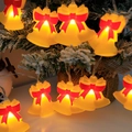 LED Christmas light string featuring warm yellow bells and red bows on a snowy tree - Christmas Bell