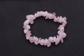 Pink rose quartz natural stone bracelet with irregular crystal chips on dark background - Rose Quartz