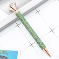 Rose gold ballpoint pen with green crystals and a large clear diamond top decoration - 1.0mm Bullet Tip / Green
